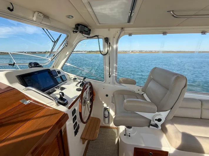 Wild Rose Yacht Photos Pics Interior of 2015 MJM 36z Downeast boat with helm, steering wheel, and navigation screens.