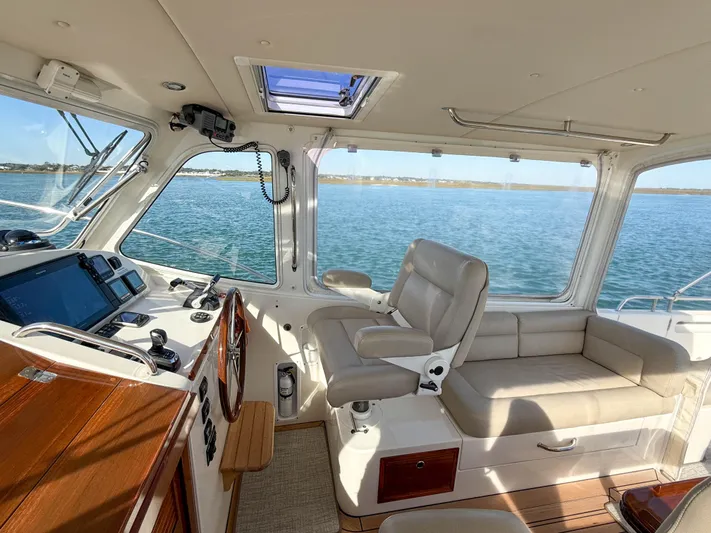 Wild Rose Yacht Photos Pics 2015 MJM 36z Downeast yacht interior with helm, seating, and ocean view.