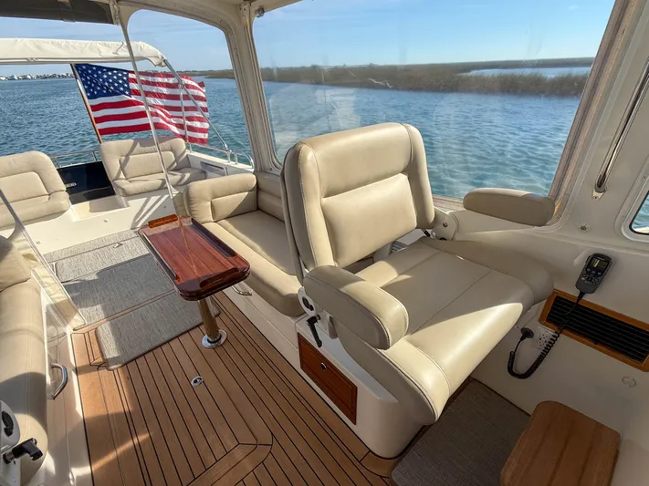 Wild Rose Yacht Photos Pics Luxurious 2015 MJM 36z Downeast boat interior with leather seating and wooden flooring.