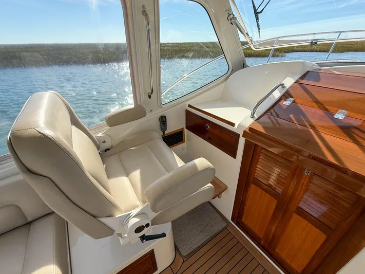 Wild Rose Yacht Photos Pics Interior of 2015 MJM 36z Downeast boat with leather seating and wooden cabinetry.