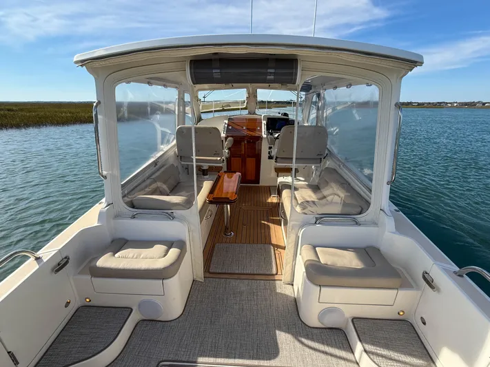 Wild Rose Yacht Photos Pics 2015 MJM 36z Downeast boat interior with seating and wooden flooring on calm water.