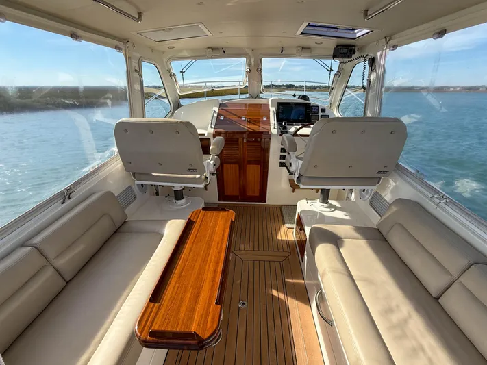 Wild Rose Yacht Photos Pics 2015 MJM 36z Downeast boat interior with plush seating and wooden accents.