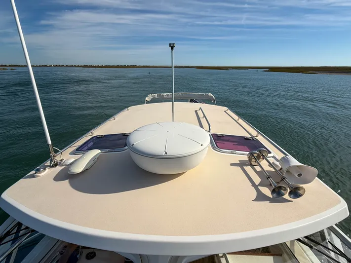 Wild Rose Yacht Photos Pics 2015 MJM 36z Downeast boat deck with clear sky and calm waters.