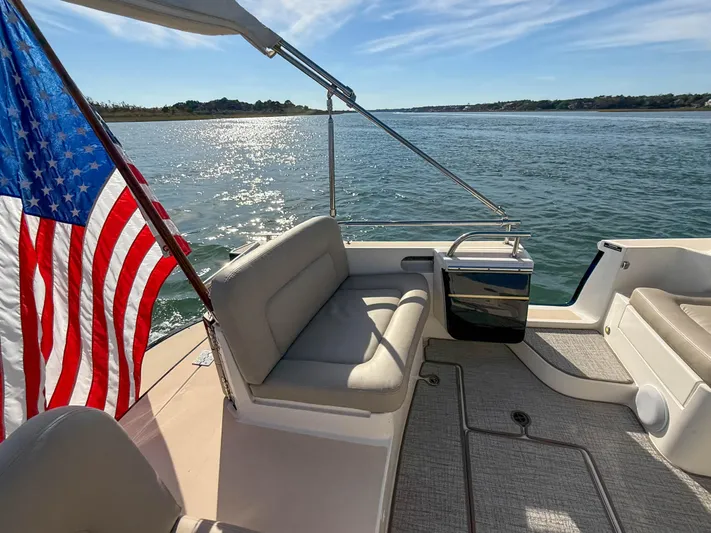 Wild Rose Yacht Photos Pics 2015 MJM 36z Downeast boat with American flag on calm water.