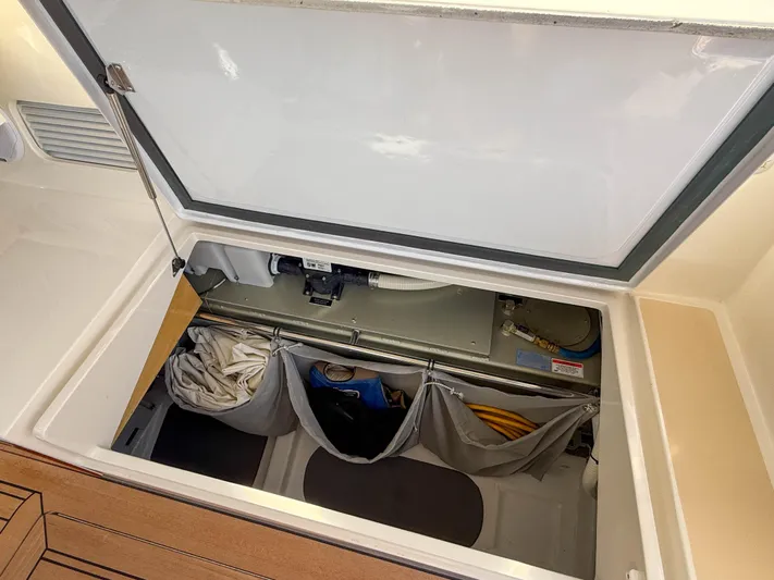 Wild Rose Yacht Photos Pics Storage compartment of 2015 MJM 36z Downeast boat, featuring organized gear and equipment.