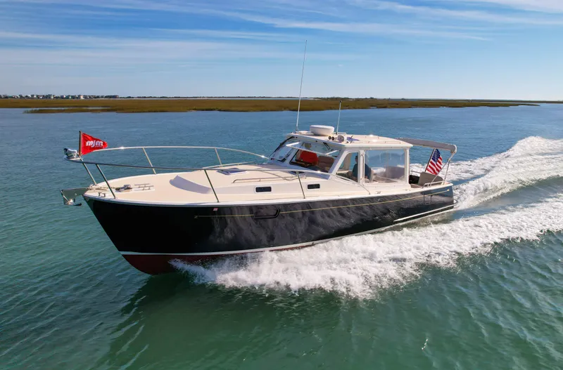 Wild Rose Yacht Photos Pics 2015 MJM 36z Downeast cruising on open water, showcasing sleek design and performance.