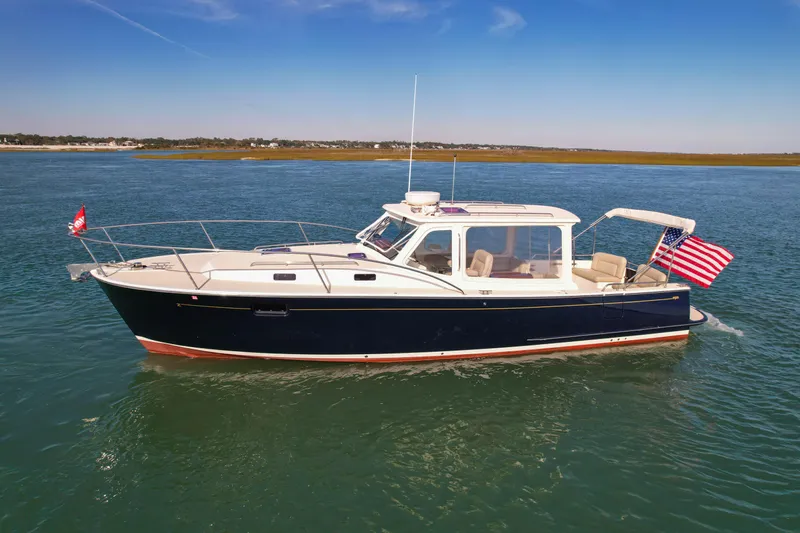 Wild Rose Yacht Photos Pics 2015 MJM 36z Downeast boat cruising on calm waters under a clear blue sky.