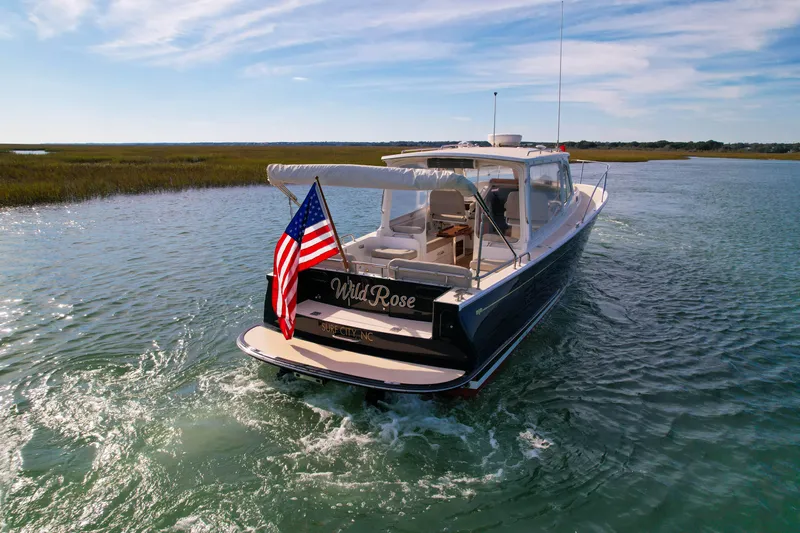 Wild Rose Yacht Photos Pics 2015 MJM 36z Downeast boat cruising on a sunny day with American flag.
