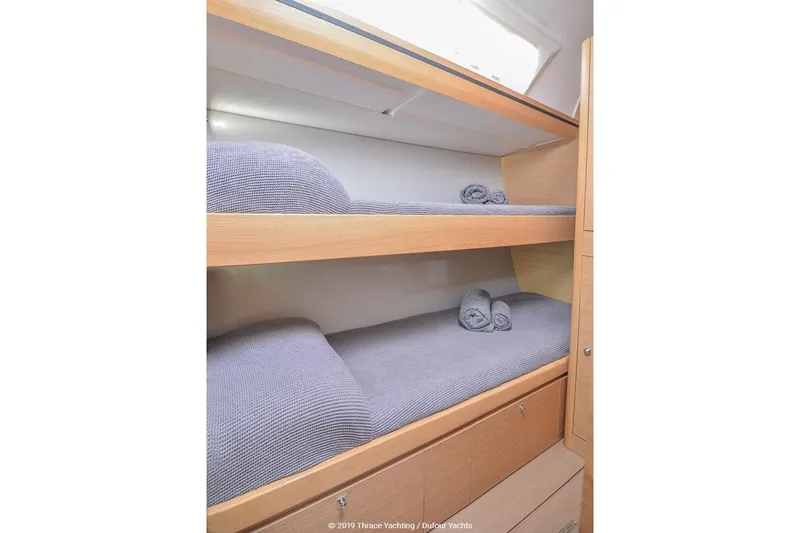  Yacht Photos Pics Bunk beds in 2018 Dufour 520 Grand Large yacht cabin with rolled towels.