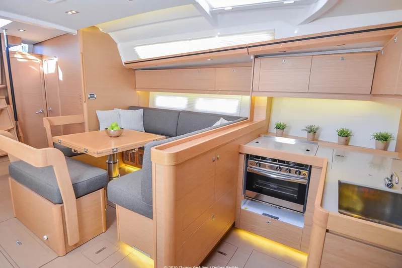  Yacht Photos Pics Interior of 2018 Dufour 520 Grand Large yacht with modern kitchen and dining area.