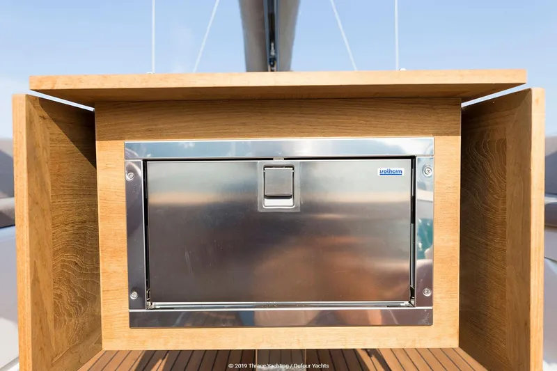  Yacht Photos Pics Stainless steel compartment on 2018 Dufour 520 Grand Large yacht, framed by wooden panels.