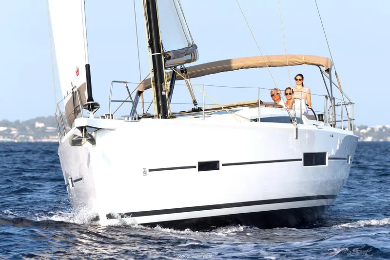  Yacht Photos Pics 2018 Dufour 520 Grand Large sailing on open water with passengers onboard.