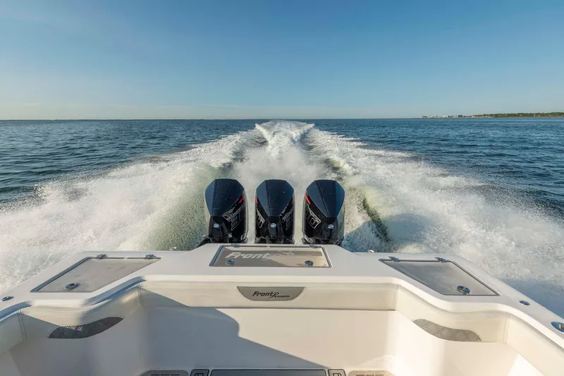 Catch 22 Yacht Photos Pics 2021 Front Runner 36 Center Console boat with triple engines cruising on open water.