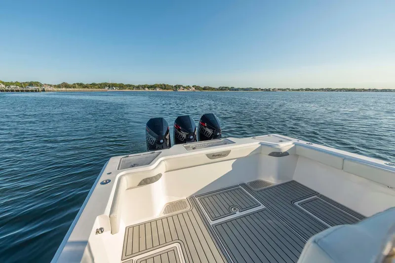 Catch 22 Yacht Photos Pics 2021 Front Runner 36 Center Console boat on calm water, featuring triple outboard engines.