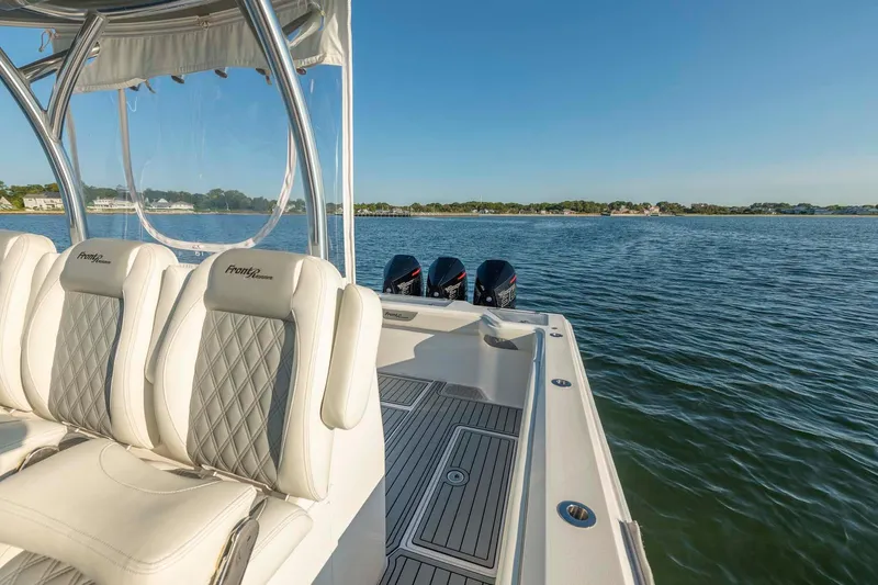 Catch 22 Yacht Photos Pics 2021 Front Runner 36 Center Console boat on water, featuring luxurious seating and triple engines.