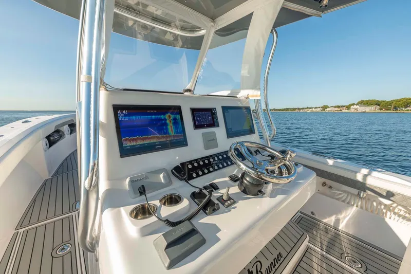 Catch 22 Yacht Photos Pics 2021 Front Runner 36 Center Console boat dashboard with navigation screens and steering wheel.