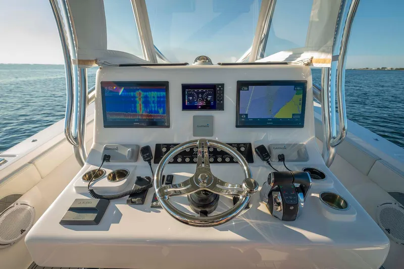 Catch 22 Yacht Photos Pics 2021 Front Runner 36 Center Console boat dashboard with dual navigation screens and steering wheel.