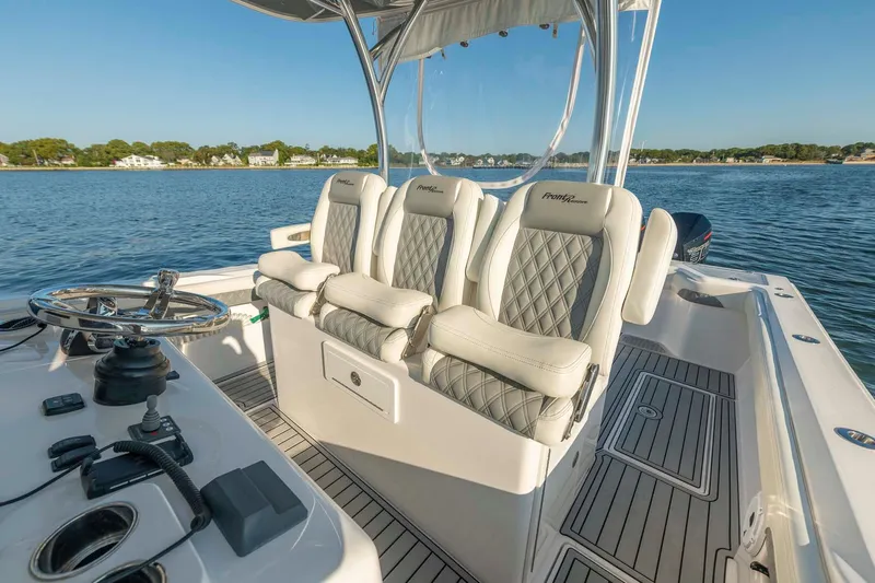 Catch 22 Yacht Photos Pics 2021 Front Runner 36 Center Console boat interior with luxurious seating on a calm lake.