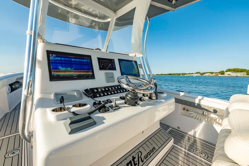 Catch 22 Yacht Photos Pics 2021 Front Runner 36 Center Console boat dashboard with navigation screens and steering wheel.