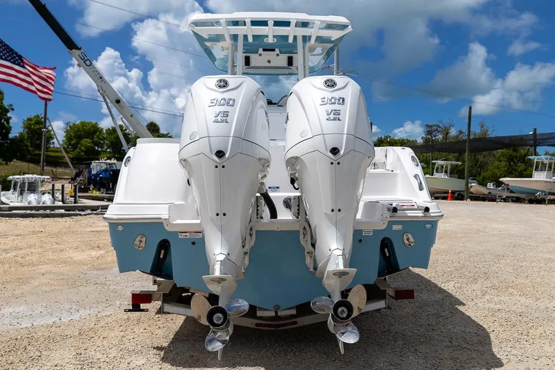  Yacht Photos Pics 2026 Sea Fox 288 Commander with twin 300 V6 engines, parked outdoors under a blue sky.