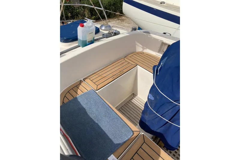  Yacht Photos Pics Cockpit of 1990 Hallberg-Rassy 36 sailboat with teak flooring and blue cover.