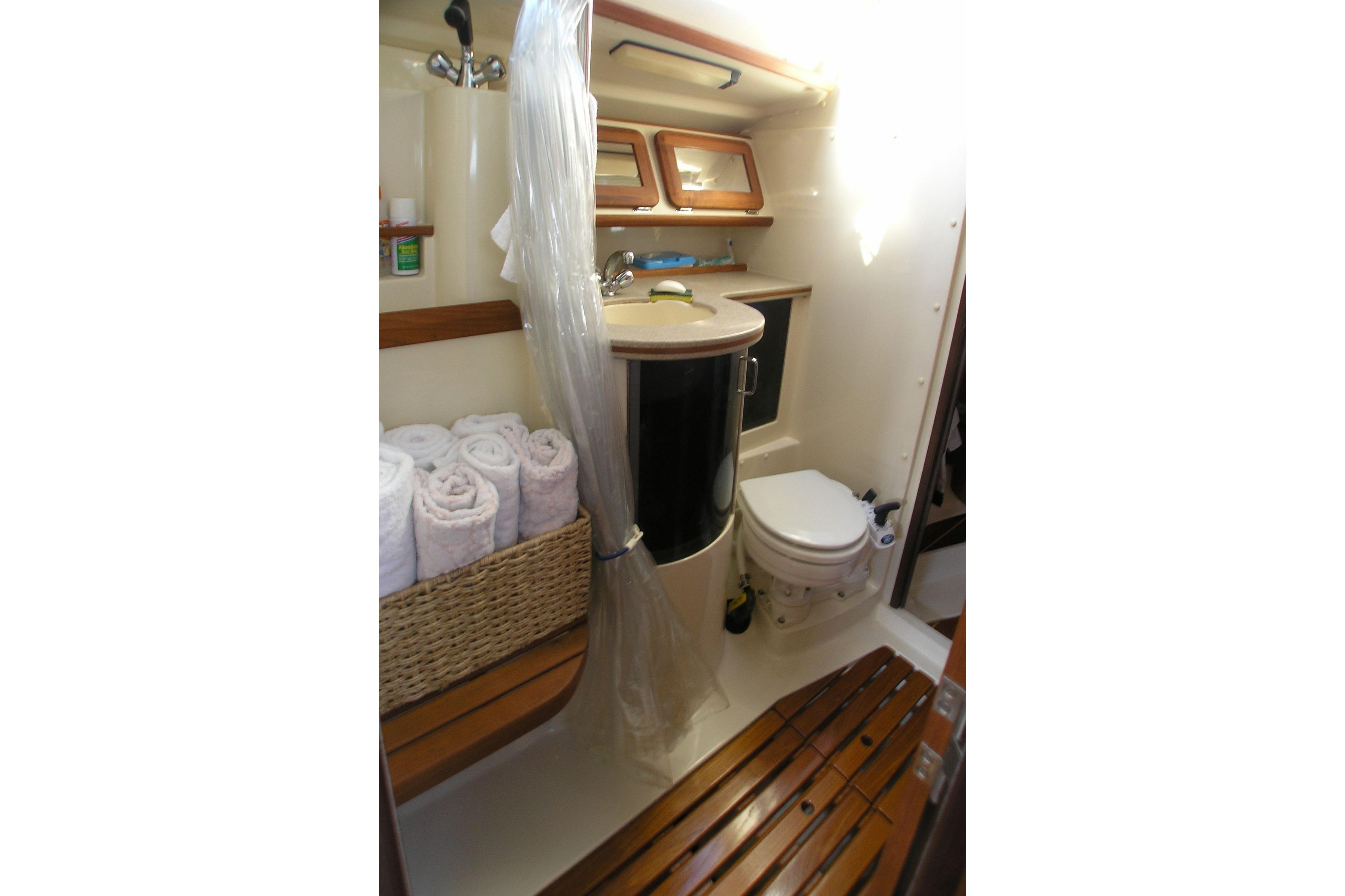 1996 Hunter 37.5 Legend yacht bathroom with shower, sink, and toilet.
