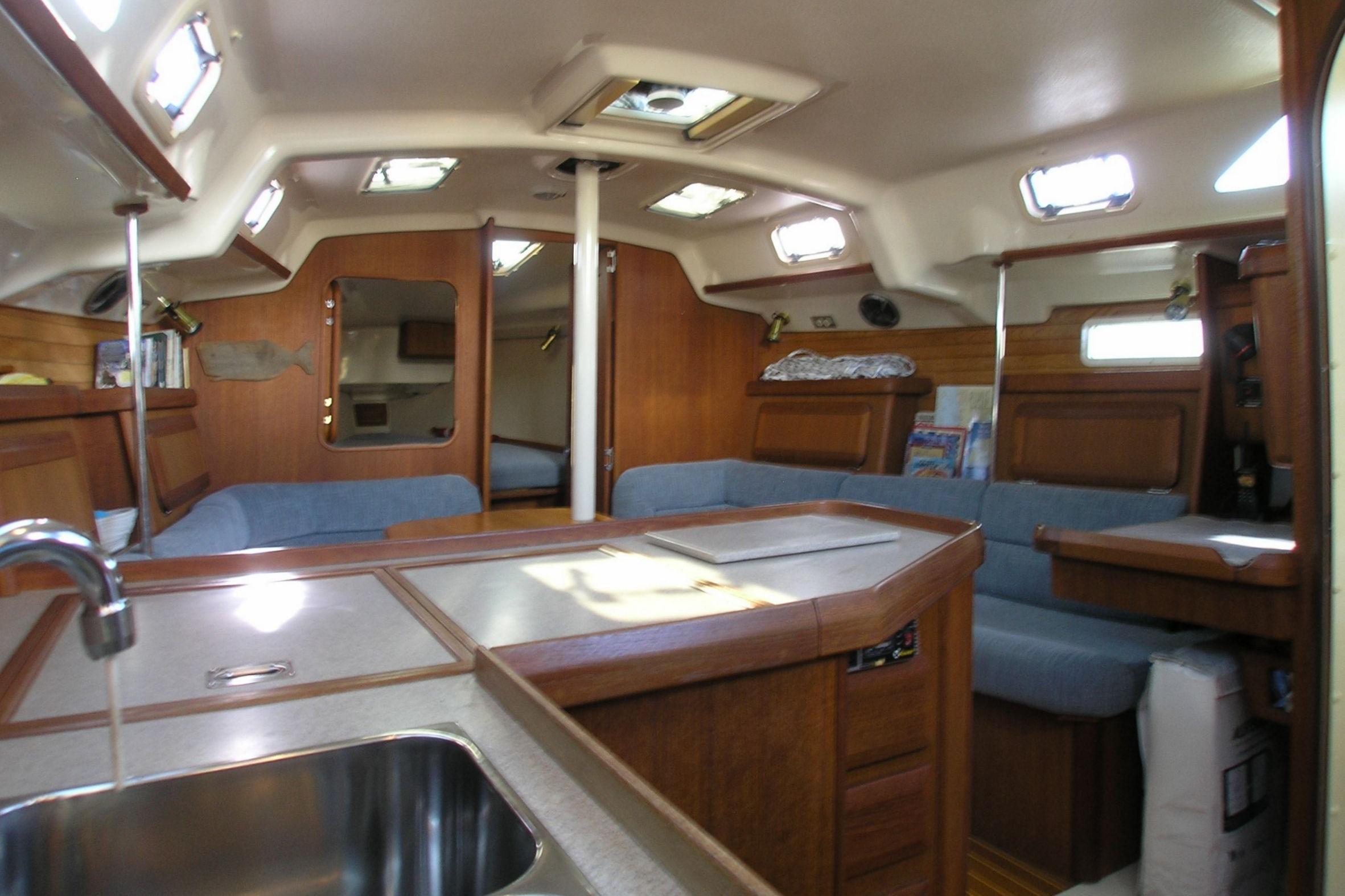 Interior of 1996 Hunter 37.5 Legend sailboat with cozy seating and wooden finishes.
