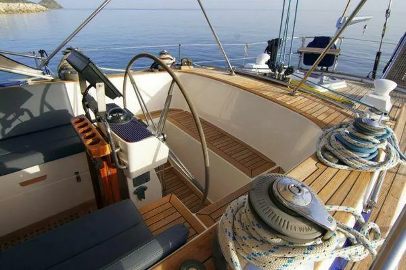 Persistence Yacht Photos Pics Cockpit of 2002 Hallberg-Rassy 53 yacht with wooden deck and steering wheel.