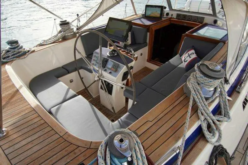 Persistence Yacht Photos Pics Luxurious 2002 Hallberg-Rassy 53 yacht cockpit with steering wheel and navigation equipment.