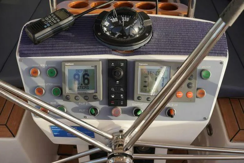 Persistence Yacht Photos Pics Control panel of a 2002 Hallberg-Rassy 53 yacht with compass and navigation instruments.