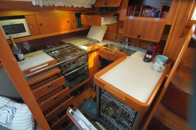 Persistence Yacht Photos Pics Cozy kitchen in 2002 Hallberg-Rassy 53 yacht with stove, sink, and dishwasher.