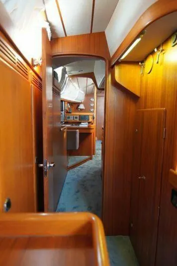 Persistence Yacht Photos Pics Interior of 2002 Hallberg-Rassy 53 yacht with wooden paneling and cozy cabin layout.