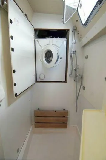 Persistence Yacht Photos Pics Laundry area with washing machine in 2002 Hallberg-Rassy 53 yacht bathroom.