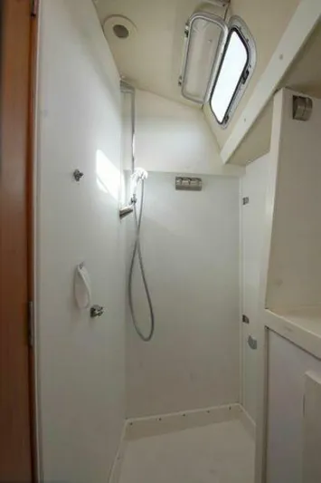 Persistence Yacht Photos Pics Shower area in a 2002 Hallberg-Rassy 53 yacht, featuring modern fixtures and natural light.