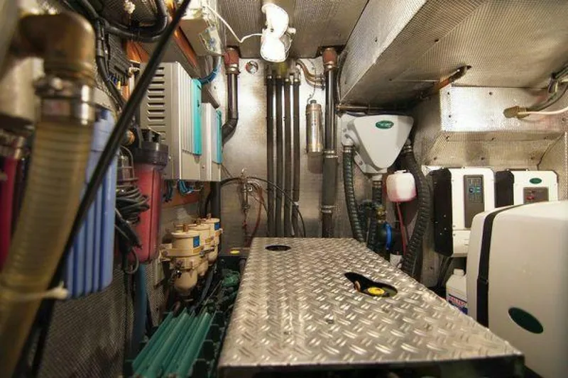 Persistence Yacht Photos Pics Engine room of 2002 Hallberg-Rassy 53 yacht, featuring mechanical equipment and piping.