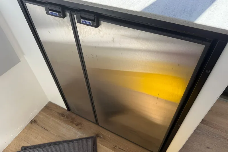  Yacht Photos Pics Stainless steel fridge in a 2023 Schionning 1850 S yacht interior.