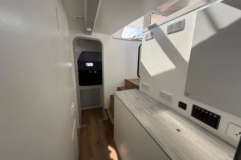  Yacht Photos Pics Interior of 2023 Schionning 1850 S catamaran, featuring modern design and wooden flooring.