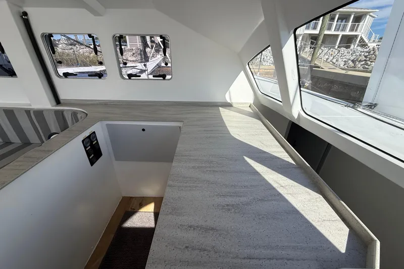  Yacht Photos Pics Modern interior of 2023 Schionning 1850 S catamaran with sleek countertops and large windows.