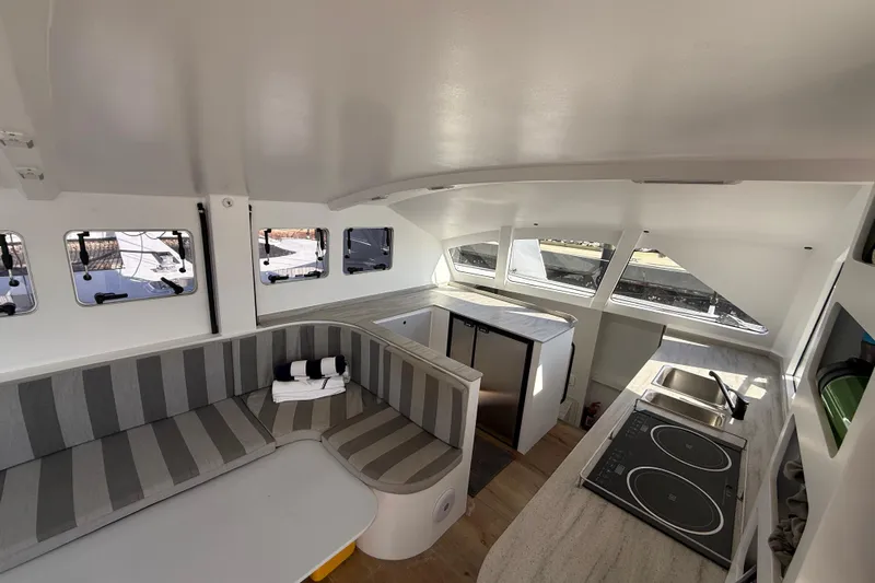  Yacht Photos Pics Interior of 2023 Schionning 1850 S catamaran with modern kitchen and seating area.