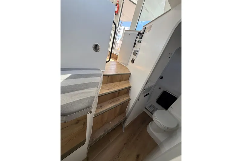  Yacht Photos Pics Interior of 2023 Schionning 1850 S yacht with wooden stairs and compact bathroom.