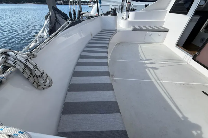  Yacht Photos Pics 2023 Schionning 1850 S yacht deck with striped seating and nautical ropes.