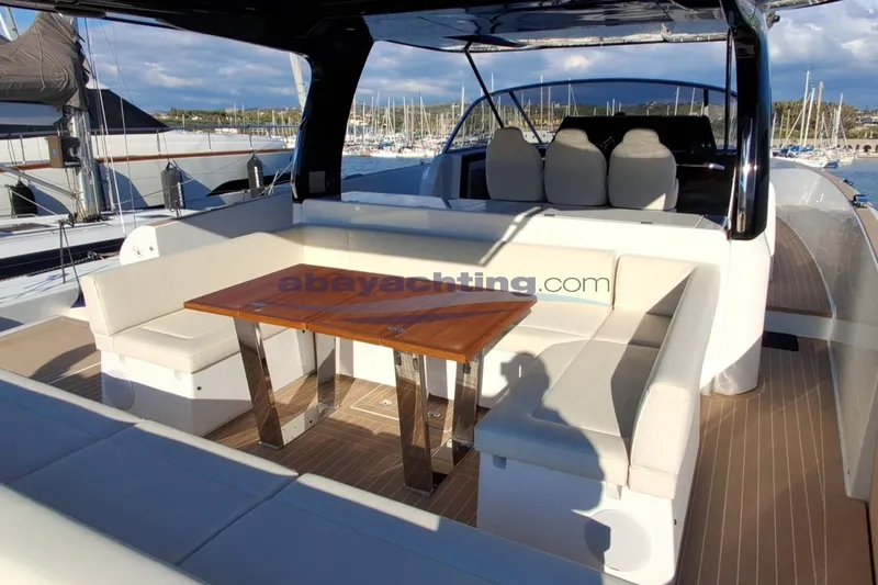  Yacht Photos Pics Luxurious 2025 Solaris Power 52 Open yacht with elegant seating and wooden table.