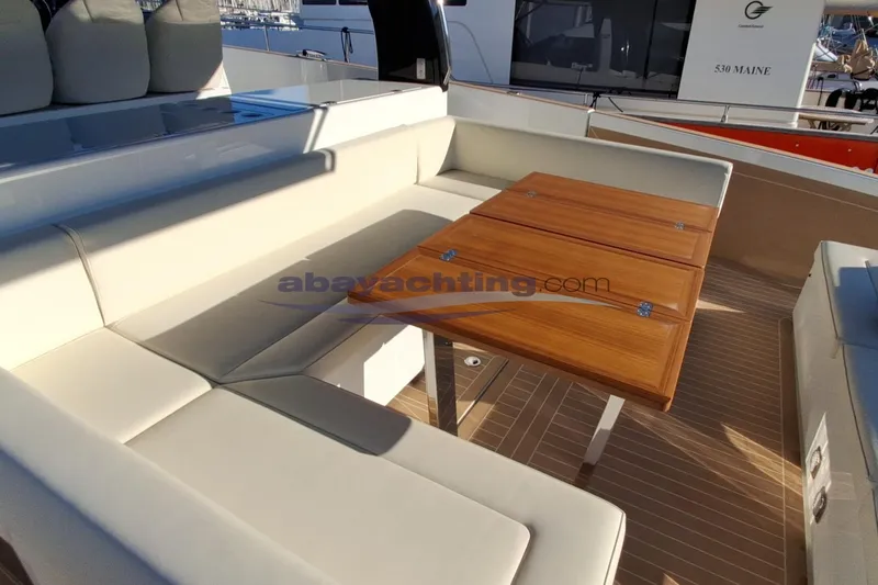  Yacht Photos Pics Luxurious seating area on 2025 Solaris Power 52 Open yacht with wooden table.