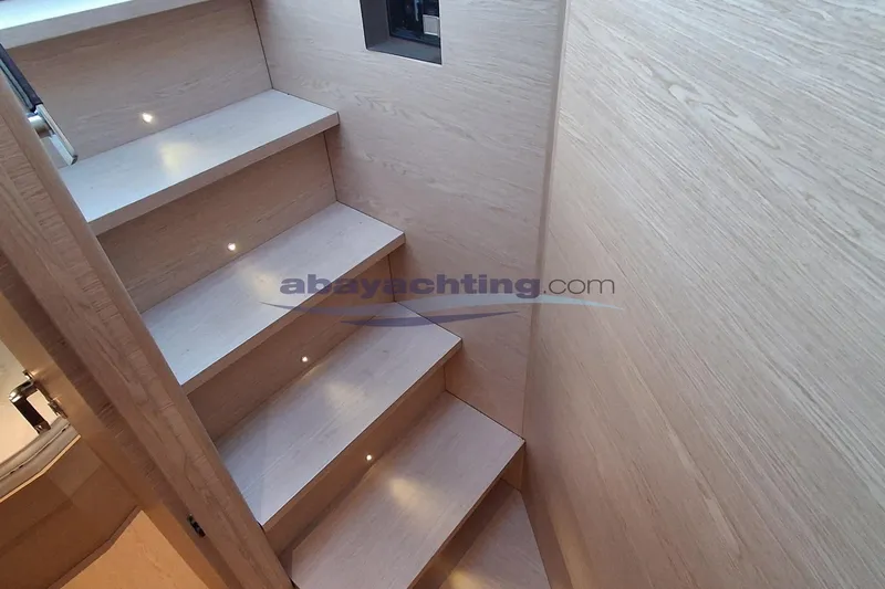  Yacht Photos Pics Staircase inside 2025 Solaris Power 52 Open yacht with wooden finish and LED lighting.