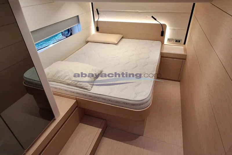  Yacht Photos Pics Luxurious cabin interior of 2025 Solaris Power 52 Open yacht, featuring a comfortable bed.