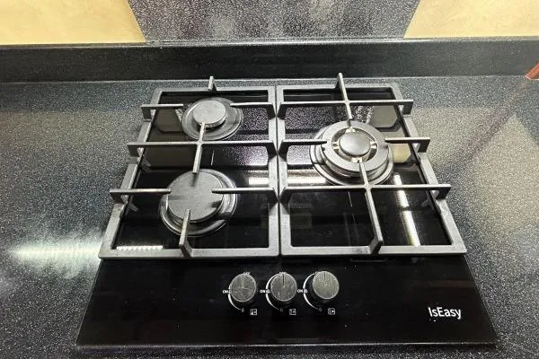 Island Hopper Yacht Photos Pics Modern black four-burner gas stove on sleek countertop, IsEasy brand.
