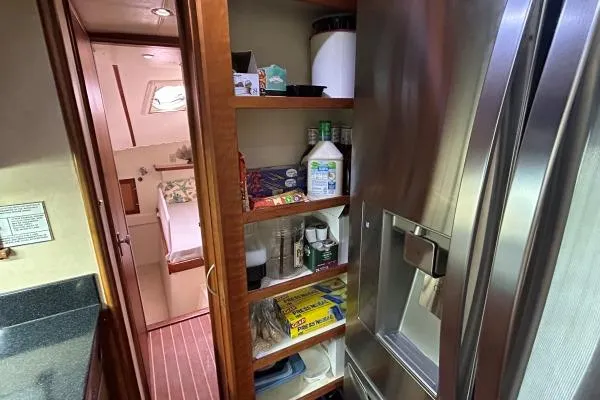 Island Hopper Yacht Photos Pics Interior of 2001 Crosswater Passagemaker 49 yacht with pantry and stainless steel fridge.