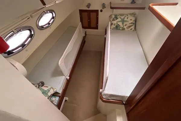 Island Hopper Yacht Photos Pics Cabin interior of 2001 Crosswater Passagemaker 49 with twin beds and portholes.