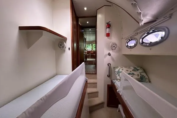 Island Hopper Yacht Photos Pics Interior of 2001 Crosswater Passagemaker 49 yacht with cozy sleeping area and portholes.