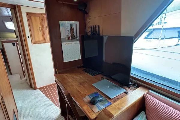 Island Hopper Yacht Photos Pics Office space inside 2001 Crosswater Passagemaker 49 yacht with desk, computer, and window view.